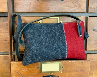 Small woolfelt crossbodybag. Minimalist design in pure wool, Zipper purse, leather handles. Red and black wool felt. Dutch Design Bags.