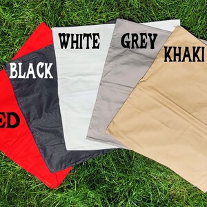 May include: Five fabric swatches in different colors: red, black, white, grey, and khaki. The swatches are arranged in a semi-circle with the red swatch at the bottom.