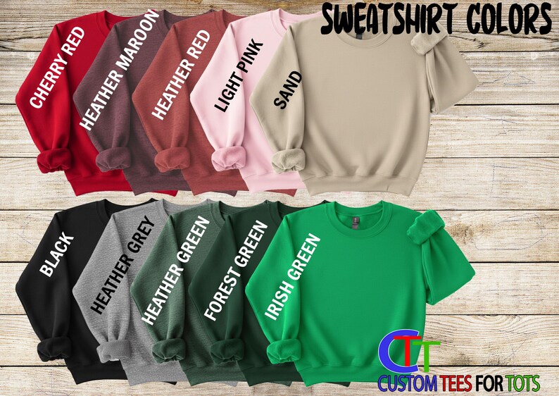 a collection of colorful sweatshirt colors, including red, pink, light pink, sand, and various shades of green, grey, and forest green.