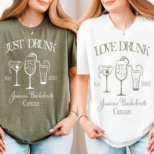 May include: Two white t-shirts with a hen party theme. The left shirt says "Just Drunk" with a cocktail, a glass of wine, and a shot glass. The right shirt says "Love Drunk" with a martini glass, a glass of wine, and a shot glass. Both shirts say "Jessica's Bachelorette Cancun" and "Est 2025".