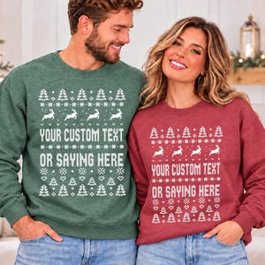 May include: A dark green sweatshirt and a maroon sweatshirt, both featuring a white knitted-style pattern of Christmas trees, reindeer, hearts, and snowflakes. The centre of each garment displays the text YOUR CUSTOM TEXT OR SAYING HERE.