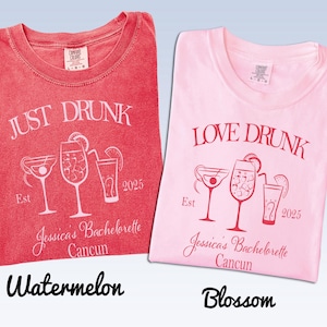 May include: Two t-shirts, one watermelon red and one blossom pink, each featuring white or dark pink graphic prints of three cocktails, the text "JUST DRUNK" or "LOVE DRUNK," "Est 2025," "Jessica's Bachelorette," and "Cancun" printed on the front.