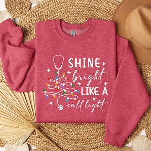 Christmas Nurse Sweatshirt: Shine Bright Like A Call Light - Hospital Worker Crewneck Sweater