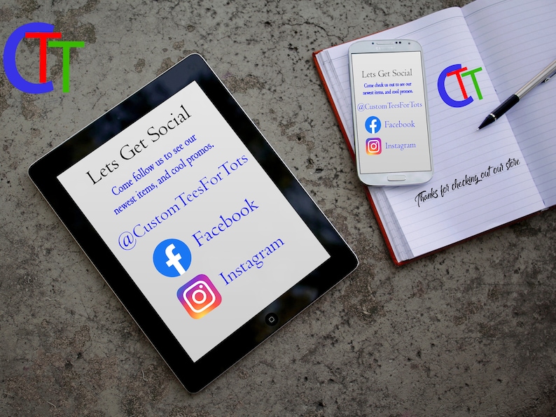 May include: A black tablet with a white screen displaying the text "Lets Get Social" and social media icons for Facebook and Instagram. The text "@Custom Tees For Tots" is also displayed on the screen. The tablet is lying on a gray surface. A white smartphone with a black screen displaying the text "Lets Get Social" and social media icons for Facebook and Instagram. The text "@Custom Tees For Tots" is also displayed on the screen. The smartphone is lying on a white notebook with the text "Thanks for checking out our store" written in black ink.