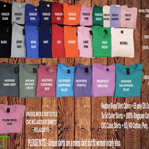 a variety of colorful t-shirts, including different colors and patterns, arranged on a wooden background.