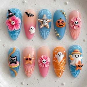 May include: A set of ten almond-shaped press-on nails featuring 3D Halloween and summer-themed decorations. Designs include a skull-centred hibiscus, a ghost, a skeleton starfish, a jack-o'-lantern, a cat on a floatie, and a ghost with a drink.