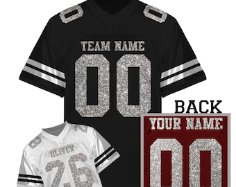 May include: A black jersey with silver glitter text reading TEAM NAME and 00 on the front, plus a white jersey with silver glitter text reading OLIVER and 26, and a maroon back panel with silver glitter text reading YOUR NAME and 00.