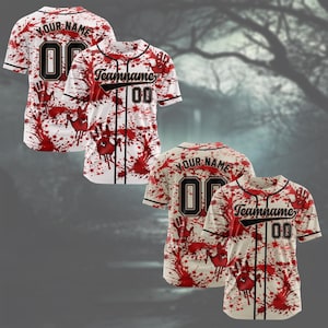 May include: A white short-sleeve baseball jersey featuring a red blood splatter pattern and handprint graphics. The front displays the text Teamname and the number 00, while the back shows Your Name and the number 00 in black outlined font.