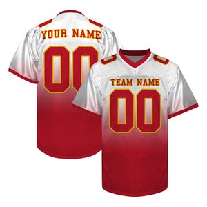 May include: White and red football jersey with the number "00" in gold. The jersey has "TEAM NAME" and "YOUR NAME" printed on it. The jersey is made of a breathable material.