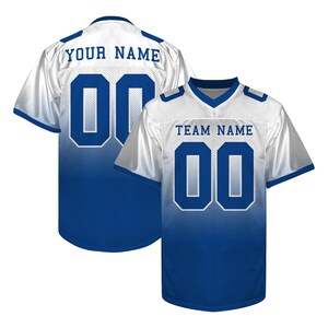 May include: Two white and blue football jerseys. One jersey displays "YOUR NAME" and the number "00" on the back. The other jersey shows "TEAM NAME" and the number "00" on the front. The jerseys have a blue to white gradient.