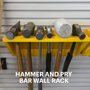 May include: A yellow wall-mounted rack holding various hammers and pry bars. The tools are arranged on a bright yellow shelf, with the handles of the tools extending downwards. The text "HAMMER AND PRY BAR WALL RACK" is displayed at the bottom.