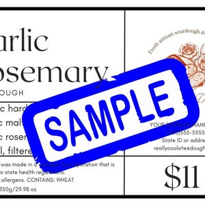 May include: A white label with black text for Garlic Rosemary Sourdough. The label includes a blue "SAMPLE" stamp, a graphic of bread and roses, and the net weight of 29.98 oz. The label also lists ingredients.