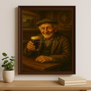 May include: A framed print of an elderly man smiling and holding a pint of dark beer. He wears a tweed cap and jacket, seated at a wooden table. The artwork has a warm, inviting color palette, with the text "FramedByIreland" visible.