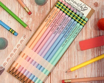 May include: A set of ten pastel-colored pencils arranged on a cardboard backing, each featuring a unique affirmation text including You Are Loved, You Are Valuable, You Bring Light, You Are Beautiful, You Are Treasured, You Are Strong, You Are Brave, You Can Do This, You Are Extraordinary, and You Belong.