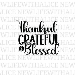 May include: Black text on a white background reads "Thankful, Grateful & Blessed" in a decorative font. The words are stacked vertically, with "Thankful" at the top and "Blessed" at the bottom. The design is suitable for home decor.