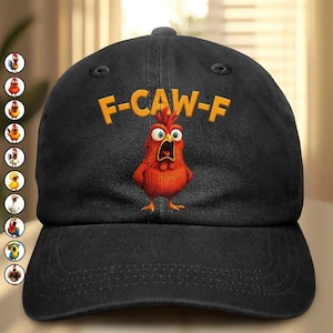 May include: Black baseball cap with the text "F-CAW-F" in yellow above a cartoon chicken with a surprised expression. The chicken is red and orange with wide eyes and an open beak. The cap has a curved brim and a button on top.