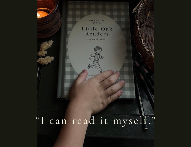 Puede incluir: Un libro de tapa dura titulado Little Oak Readers Primer One con un patr&oacute;n de cuadros vichy gris y blanco en la cubierta. La portada presenta un &oacute;valo central con una ilustraci&oacute;n en blanco y negro de un ni&ntilde;o corriendo y el texto I can read it myself.