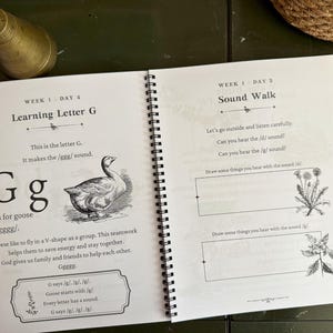 May include: A spiral-bound educational workbook open to two pages. The left page is titled Learning Letter G and features a goose illustration with text about the letter G. The right page is titled Sound Walk with prompts to draw items.