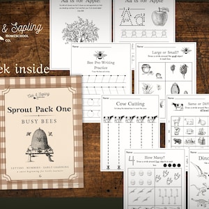 May include: A collection of educational worksheets for early learners. The worksheets include activities such as letter tracing, counting, and cutting exercises. The cover of the "Sprout Pack One" features a beehive illustration. The text "Oak & Sapling Homeschool Co." is visible.