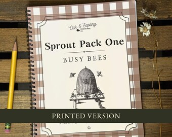 May include: A spiral-bound workbook titled Sprout Pack One Busy Bees with a brown and white gingham border. The cover features a black and white illustration of a beehive on a stand, the Oak & Sapling logo, and a black banner reading PRINTED VERSION.
