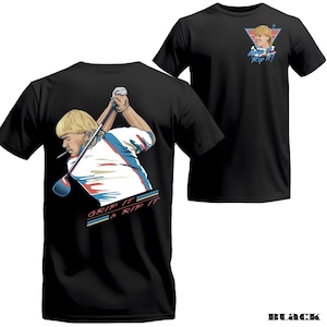 May include: Black t-shirt featuring a cartoon illustration of a golfer with a cigarette, swinging a golf club. The shirt has the text "Grip It & Rip It" on the back and a smaller graphic with text on the front. The shirt is a classic crew neck.