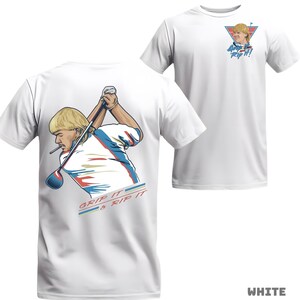 May include: White t-shirt featuring a cartoon illustration of a golfer with a mullet, swinging a golf club. The shirt has the text "GRIP IT & RIP IT" on the back and a smaller graphic with the text "GRIP IT & RIP IT!" on the front.