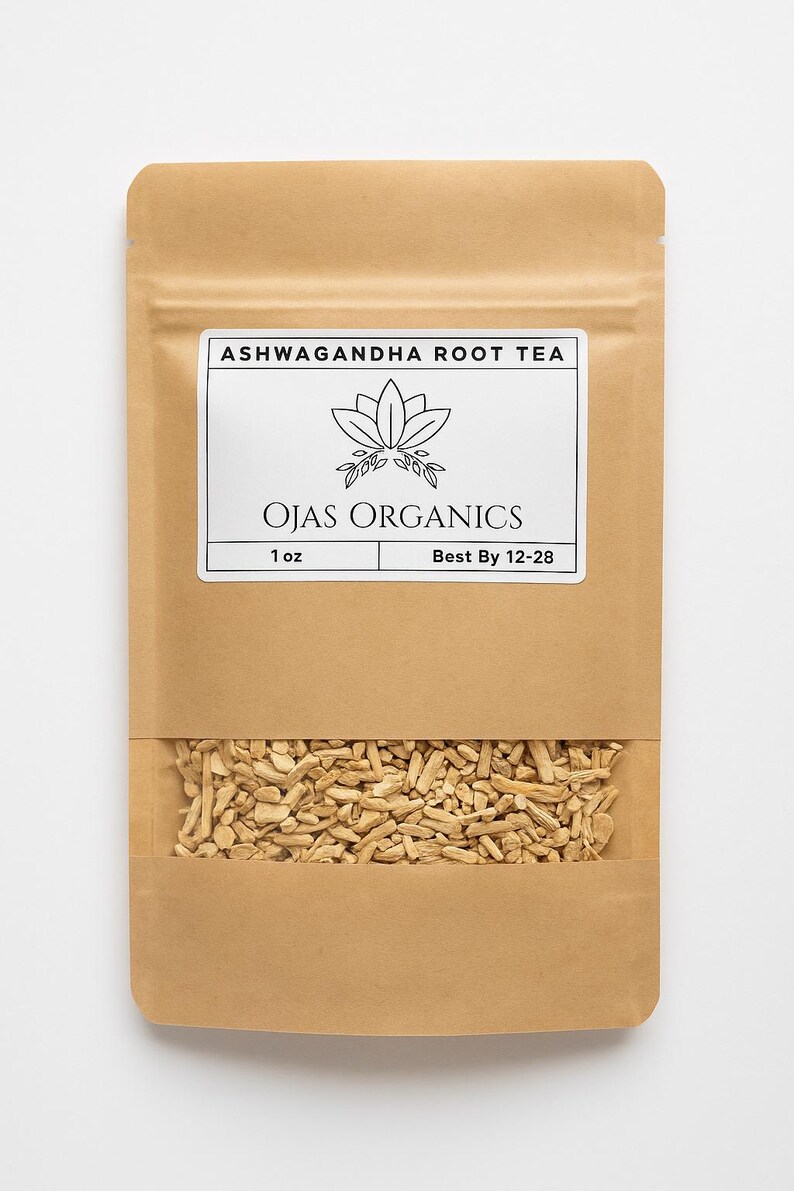 May include: A brown paper bag of Ashwagandha Root Tea from Ojas Organics. The bag has a clear window showing the tea inside. The label reads "Ashwagandha Root Tea" and "Ojas Organics". The bag contains 28 grams of tea.