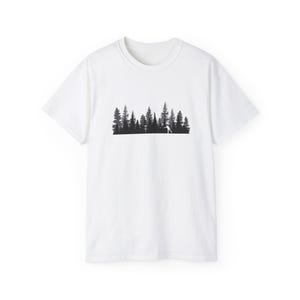 May include: White t-shirt with a black silhouette of a forest and a person throwing a disc. The design is centered. The shirt is made of a soft, breathable fabric, suitable for casual wear.