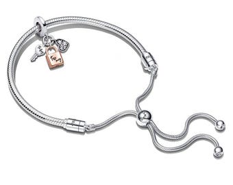 May include: A silver adjustable bracelet with a snake chain design. The bracelet features charms including a key, a padlock with the words "To my", and a heart-shaped charm. The bracelet is displayed on a white background.