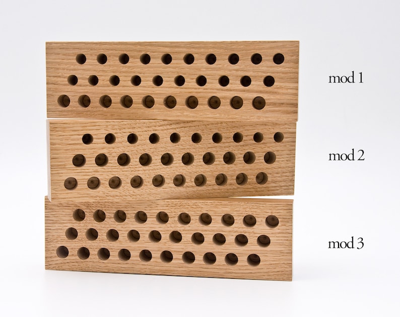 May include: Three wooden blocks with a grid of holes, labeled "mod 1", "mod 2", and "mod 3".