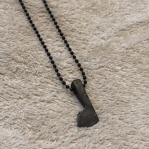 May include: A white ceramic mug with a black handle and the text "But First, Coffee" in a bold, black font. The mug is set against a blurred background, suggesting a cozy setting. The mug appears to be approximately 4 inches tall.