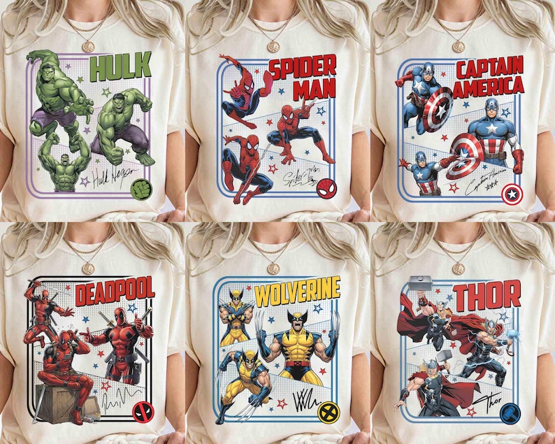 May include: Cream-coloured t-shirts showcasing Marvel superheroes: Hulk, Spider-Man, Captain America, Deadpool, Wolverine, and Thor. Each shirt has a character image, name, and signature within a framed design. The shirts are worn by a person.