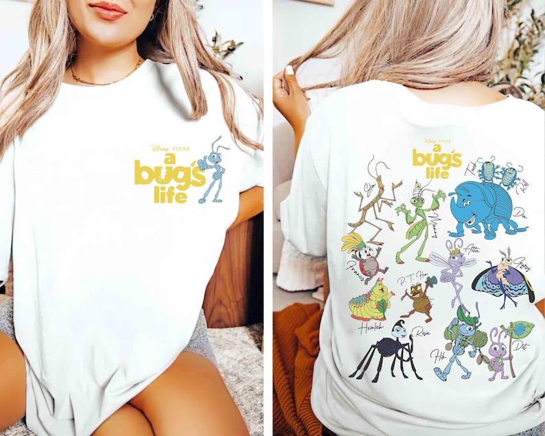 May include: White t-shirt with the words "a bug's life" in yellow and a blue ant illustration. The back of the shirt showcases colourful cartoon bug characters, including a blue elephant-like bug and a green grasshopper.
