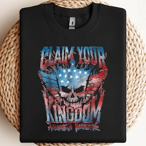May include: Black crew neck sweatshirt with a graphic design. The design features a skull with an American flag motif, flames, and the text "CLAIM YOUR KINGDOM AMERICAN NIGHTMARE" in red, white, and blue.
