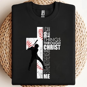 May include: Black sweatshirt with a baseball player silhouette and a white cross design. The cross incorporates baseball stitching and the text "I can do all things through Christ who strengthens me."