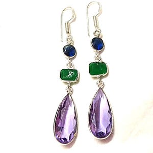 May include: A pair of silver-toned drop earrings. Each earring has a blue, green, and purple gemstone arrangement. The top stone is a small blue circle, followed by a green rectangle, and a large purple teardrop shape at the base.