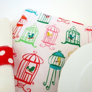 Pair of Reversible Placemats and Napkin Rings: Colorful Birdcages with Red Polka Dots image 1