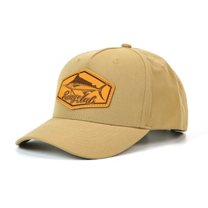 May include: Tan baseball cap with a curved brim. The cap features a brown leather patch with a marlin fish illustration and the text "Rangelab" in a script font. The cap is made of a durable fabric and has a structured crown.