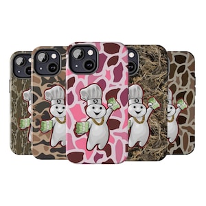 May include: A collection of phone cases featuring a cartoon chef character holding stacks of money. The cases have various camouflage and abstract patterns in shades of brown, pink, and green. The chef character wears a gold chain and chef's hat.