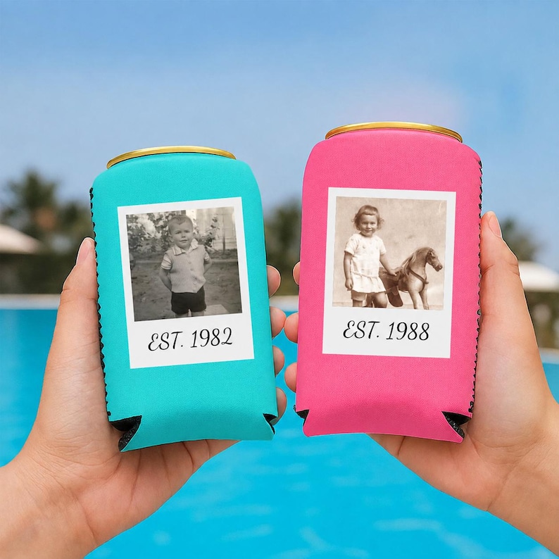 May include: Two foam can coolers, one turquoise and one pink, each featuring a white square frame containing a black and white photograph. The turquoise cooler displays a child and the text EST. 1982, while the pink cooler shows a child with a toy horse and the text EST. 1988.