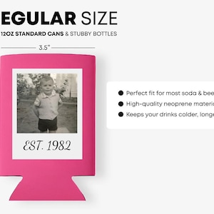 May include: A bright pink beverage cooler sleeve featuring a white square frame containing a black and white photograph of a child and the text EST. 1982. The sleeve measures 3.5 inches wide by 4.3 inches high and fits 12oz standard cans and stubby bottles.
