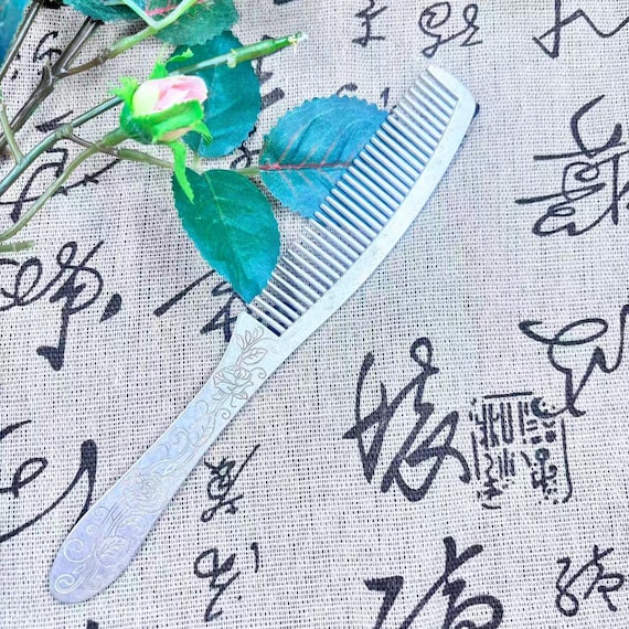 A silver-plated peony modeled on a botanical/biological specimen — where hair accessory meets naturalist art object.