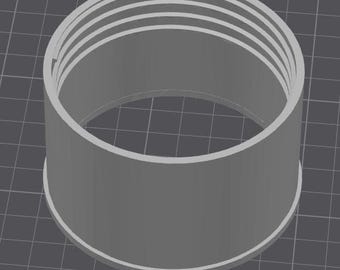 May include: A cylindrical, gray 3D-printed object with a series of concentric rings at the top. The object has a wide base and a smooth, untextured surface. The object is likely a component or part of a larger assembly.