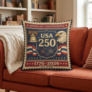 May include: Square throw pillow with a vintage-style design celebrating American Independence. The pillow features a stamp-like graphic with the text "USA 250", an eagle, the Liberty Bell, and the years 1776-2026.