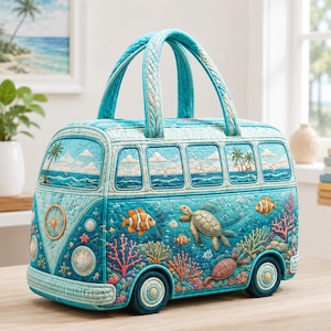 May include: A quilted fabric bag shaped like a vintage van in shades of blue and teal. The exterior features an ocean scene with a sea turtle, clownfish, and coral reefs. The top section depicts a beach landscape with palm trees and clouds.