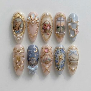 May include: A set of ten almond-shaped press-on nails featuring intricate 3D designs including gold frames, pearls, miniature paintings of a basket of flowers, a window view, a carriage, a fan, a bird, a sofa, bows, and celestial moon motifs.