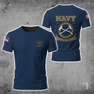 May include: Navy blue t-shirt featuring the text "UNITED STATES NAVY" and a crossed hammer and axe design. The back of the shirt displays the same text and design, with "DAMAGE CONTROLMAN" below. An American flag is on the sleeve.