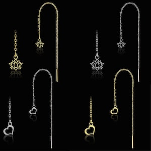 Pode incluir: Quatro brincos de fio com designs de corrente delicados. Dois brincos são em tom dourado com um pingente de flor de lótus e um pingente de coração. Dois brincos são em tom prateado com um pingente de flor de lótus e um pingente de coração.