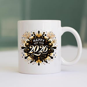 May include: White ceramic mug with a black and gold "Happy New Year 2026" design. The design features fireworks, stars, and decorative elements. The mug has a curved handle and a smooth, glossy finish.