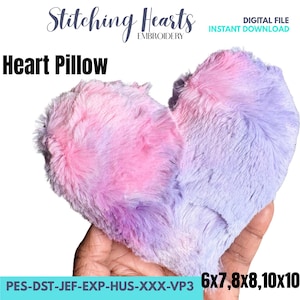 May include: A heart-shaped pillow with a soft, fluffy texture. The pillow is a blend of pink and purple hues, creating a tie-dye effect. The image includes the text "Heart Pillow" and "Digital File Instant Download".